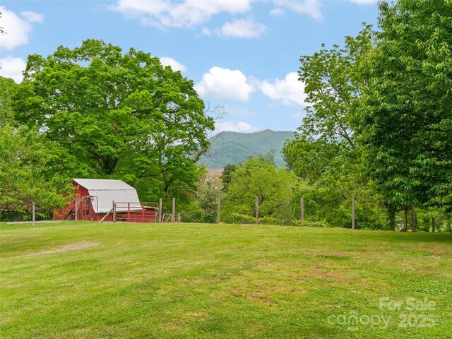 391 Ellen Ave, Canton, NC 28716 - view of grassy yard featuring a barn, a mountain view, and an outbuilding
