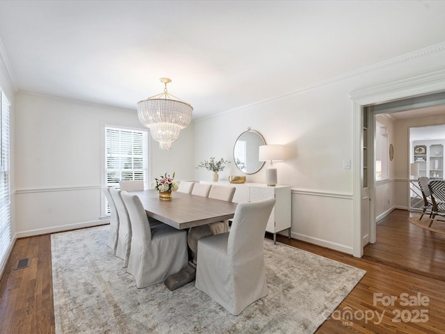 2919 Wickersham Rd, Charlotte, NC 28211 - dining area featuring a chandelier, ornamental molding, wood finished floors, and baseboards