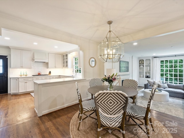 2919 Wickersham Rd, Charlotte, NC 28211 - dining area with wood finished floors, a chandelier, crown molding, and recessed lighting