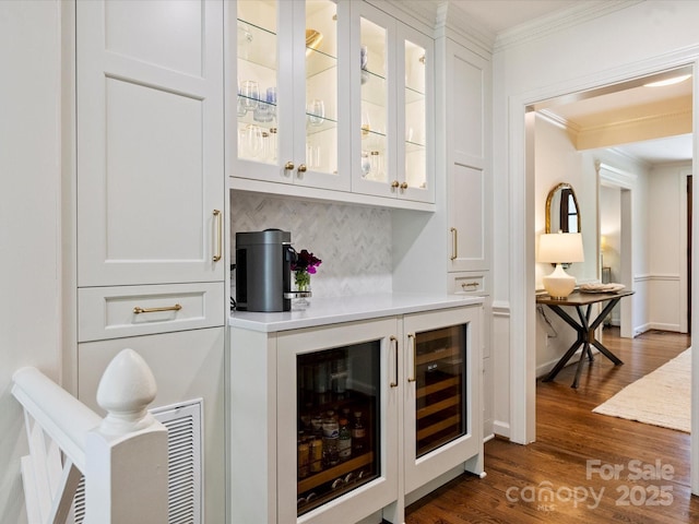 2919 Wickersham Rd, Charlotte, NC 28211 - indoor dry bar with ornamental molding, beverage cooler, dark wood-style flooring, and decorative backsplash