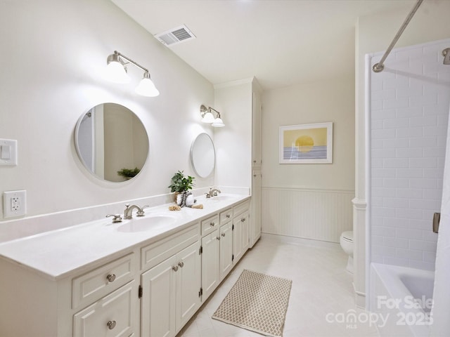 2919 Wickersham Rd, Charlotte, NC 28211 - bathroom featuring double vanity, toilet, wainscoting, washtub / shower combination, and tile patterned floors