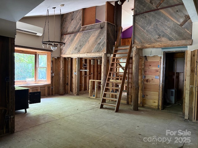 257 River Rd Unit 88, Newland, NC 28657 - miscellaneous room with a wall mounted AC, wood walls, and stairway