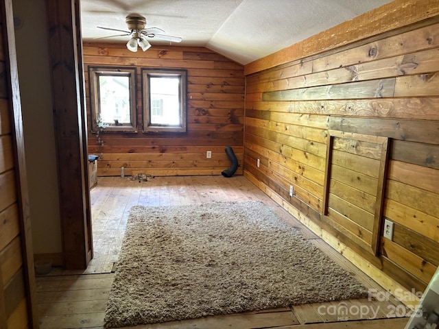 257 River Rd Unit 88, Newland, NC 28657 - additional living space featuring vaulted ceiling, a textured ceiling, wooden walls, hardwood / wood-style floors, and ceiling fan