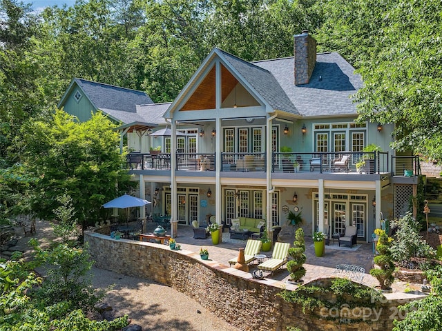 92 Island View Ct, Mill Spring, NC 28756 - back of property with french doors, a patio area, a chimney, and a balcony
