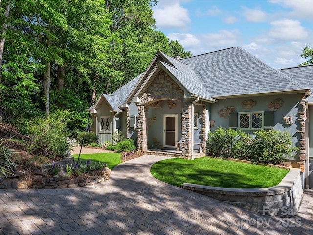 92 Island View Ct, Mill Spring, NC 28756 - tudor house featuring stone siding, a front yard, a shingled roof, and stucco siding