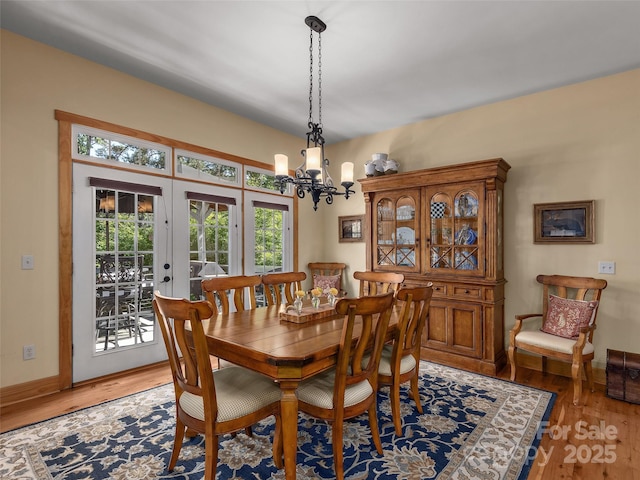 92 Island View Ct, Mill Spring, NC 28756 - dining area featuring a chandelier, light wood-style floors, baseboards, and french doors