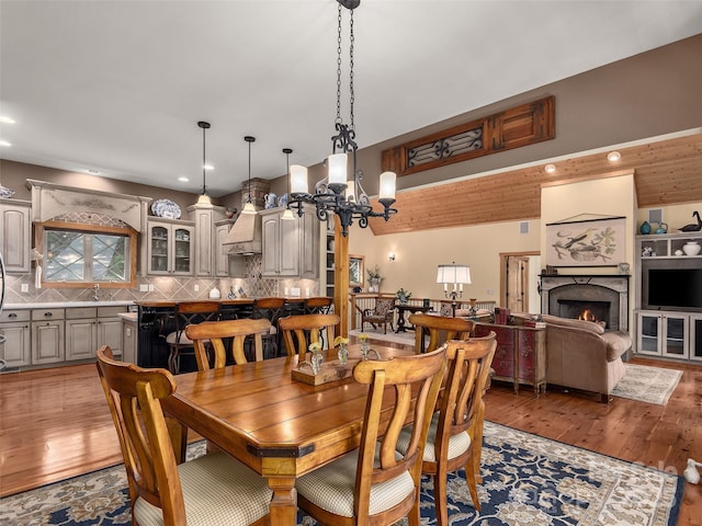 92 Island View Ct, Mill Spring, NC 28756 - dining area with a chandelier, light wood-style floors, a lit fireplace, and recessed lighting
