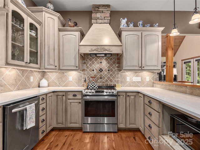92 Island View Ct, Mill Spring, NC 28756 - kitchen with stainless steel appliances, custom exhaust hood, light countertops, and light wood-style floors