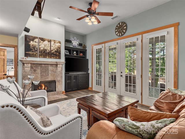 92 Island View Ct, Mill Spring, NC 28756 - living room with french doors, ceiling fan, a tiled fireplace, and wood finished floors