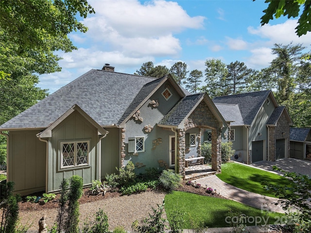 92 Island View Ct, Mill Spring, NC 28756 - view of front facade featuring a chimney, board and batten siding, roof with shingles, stone siding, and a front yard