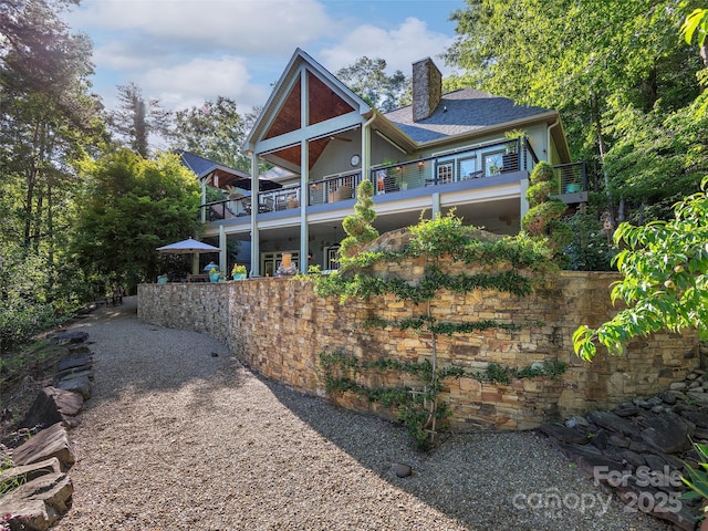 92 Island View Ct, Mill Spring, NC 28756 - back of property with a balcony and a chimney