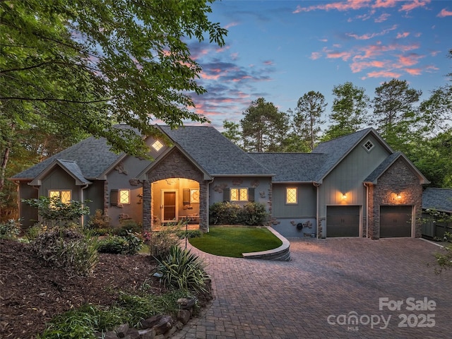92 Island View Ct, Mill Spring, NC 28756 - traditional home featuring stone siding, decorative driveway, a shingled roof, an attached garage, and board and batten siding
