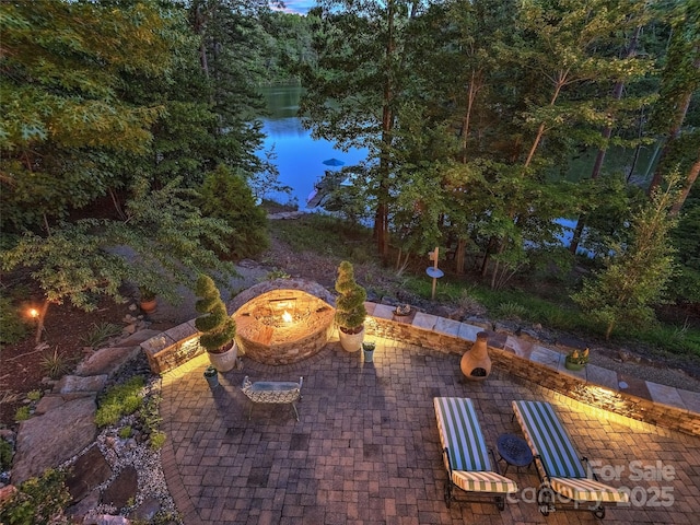 92 Island View Ct, Mill Spring, NC 28756 - view of patio featuring a fire pit and a water view