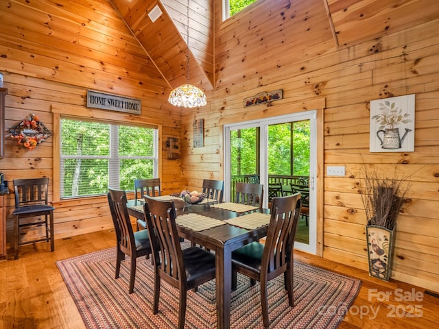 287 Matho Trce, Lake Lure, NC 28746 - dining space with wooden walls, high vaulted ceiling, and light wood finished floors