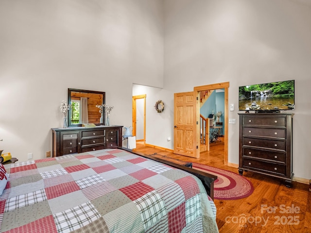 287 Matho Trce, Lake Lure, NC 28746 - bedroom with wood finished floors, a high ceiling, and baseboards