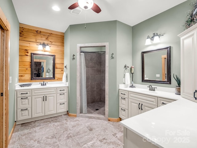 287 Matho Trce, Lake Lure, NC 28746 - bathroom featuring a ceiling fan, tiled shower, two vanities, baseboards, and wooden walls
