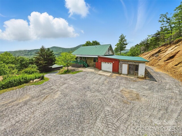 33 Faholoa Ridge Rd, Black Mountain, NC 28711 - view of home's exterior with a garage, dirt driveway, and metal roof
