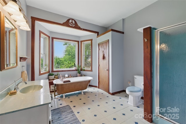 33 Faholoa Ridge Rd, Black Mountain, NC 28711 - bathroom featuring vanity, a freestanding bath, toilet, a shower stall, and baseboards