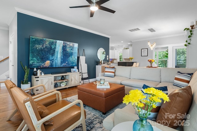 1067 33rd Avenue Loop NE, Hickory, NC 28601 - living room featuring crown molding, wood finished floors, a ceiling fan, and a chandelier
