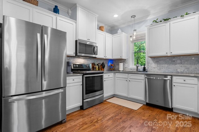 1067 33rd Avenue Loop NE, Hickory, NC 28601 - kitchen with appliances with stainless steel finishes, ornamental molding, a sink, white cabinets, and recessed lighting