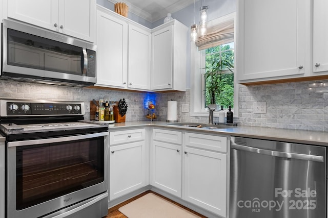 1067 33rd Avenue Loop NE, Hickory, NC 28601 - kitchen featuring appliances with stainless steel finishes, a sink, light countertops, white cabinetry, and backsplash