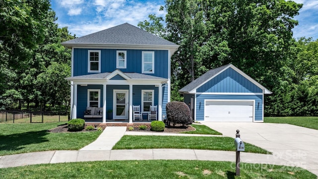 1067 33rd Avenue Loop NE, Hickory, NC 28601 - traditional style home with covered porch, board and batten siding, a garage, and driveway