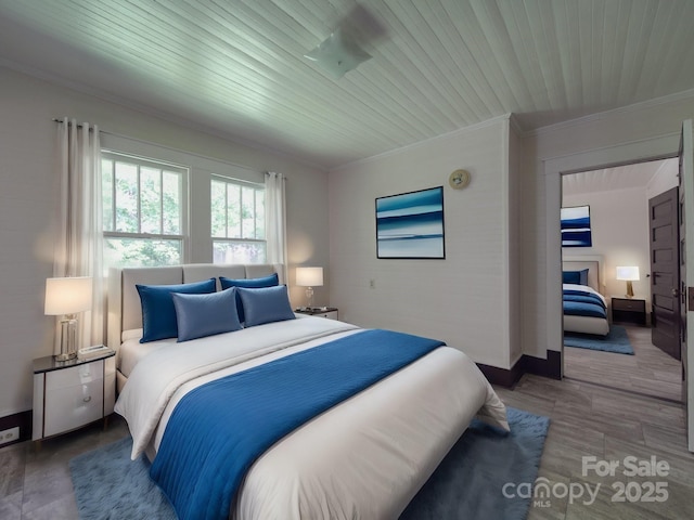 435 W Whitley St, Norwood, NC 28128 - bedroom with ornamental molding, baseboards, wooden ceiling, and wood finished floors