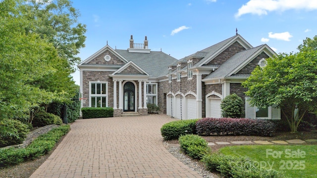 123 Sailview Rd, Mooresville, NC 28117 - view of front of home with stone siding, decorative driveway, and a chimney