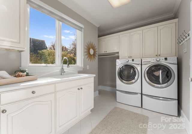 123 Sailview Rd, Mooresville, NC 28117 - laundry room featuring cabinet space, crown molding, washer and dryer, light tile patterned floors, and baseboards