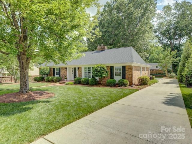 6116 Springhouse Ln, Charlotte, NC 28211 - view of front facade featuring brick siding, driveway, a chimney, a front lawn, and a shingled roof