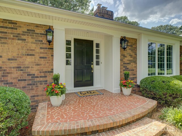 6116 Springhouse Ln, Charlotte, NC 28211 - entrance to property with a chimney, brick siding, and a porch