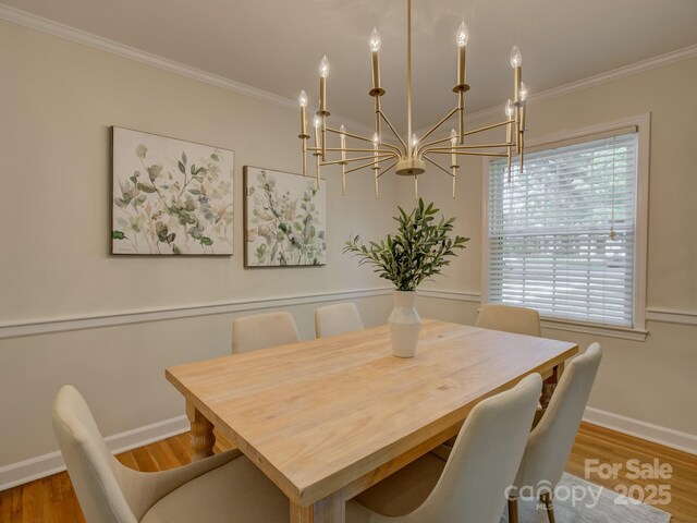 6116 Springhouse Ln, Charlotte, NC 28211 - dining room with a chandelier, ornamental molding, and wood finished floors