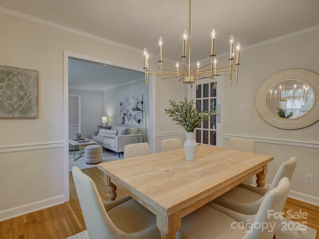 6116 Springhouse Ln, Charlotte, NC 28211 - dining space with a chandelier, ornamental molding, and wood finished floors