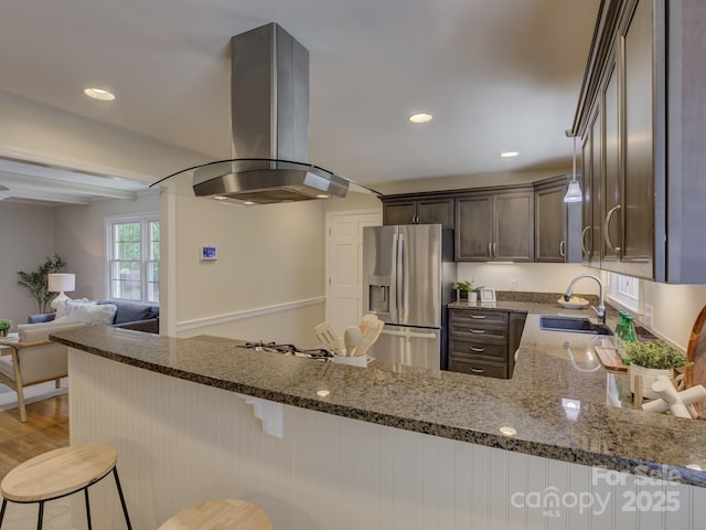 6116 Springhouse Ln, Charlotte, NC 28211 - kitchen with stainless steel refrigerator with ice dispenser, island range hood, dark stone counters, dark brown cabinets, and recessed lighting