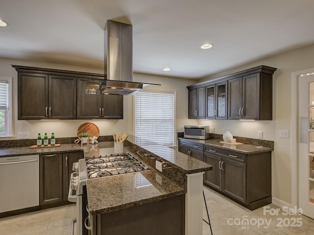 6116 Springhouse Ln, Charlotte, NC 28211 - kitchen featuring island exhaust hood, appliances with stainless steel finishes, plenty of natural light, dark brown cabinetry, and recessed lighting