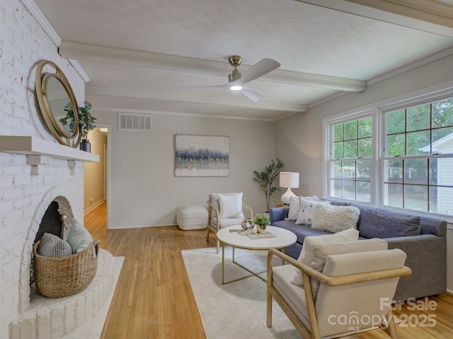 6116 Springhouse Ln, Charlotte, NC 28211 - living area featuring beam ceiling, wood finished floors, ceiling fan, crown molding, and a fireplace