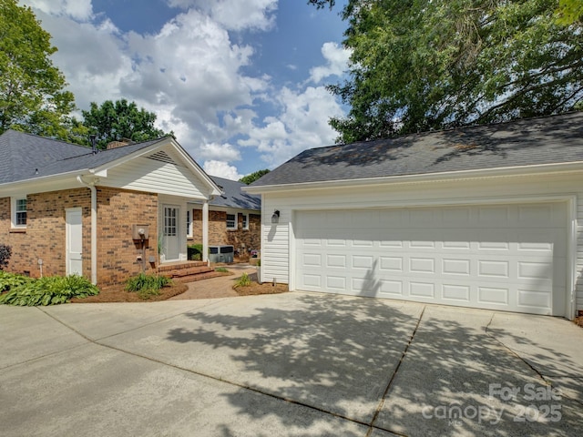 6116 Springhouse Ln, Charlotte, NC 28211 - view of side of home featuring driveway, brick siding, and roof with shingles