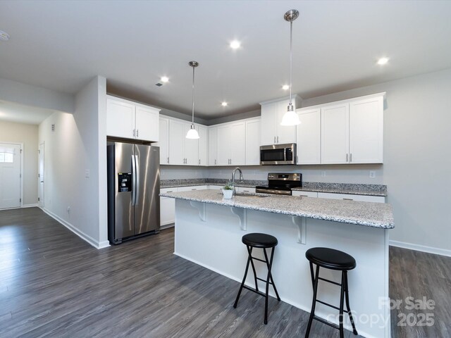 403 Park Meadows Dr, Matthews, NC 28104 - kitchen with appliances with stainless steel finishes, a sink, a kitchen island with sink, dark wood-style flooring, and white cabinetry