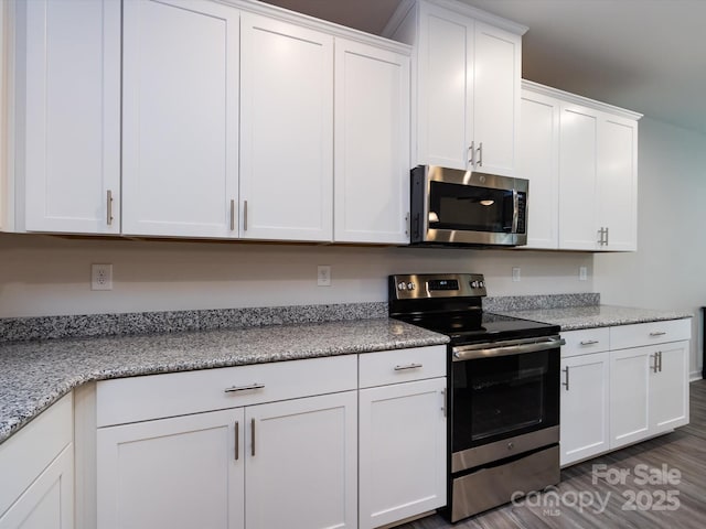 403 Park Meadows Dr, Matthews, NC 28104 - kitchen with stainless steel appliances, white cabinets, dark wood-style flooring, and light stone countertops