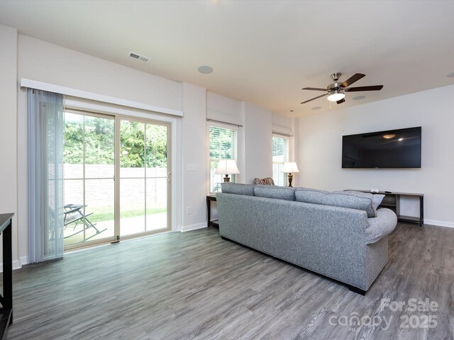 403 Park Meadows Dr, Matthews, NC 28104 - living area featuring wood finished floors, baseboards, and healthy amount of natural light