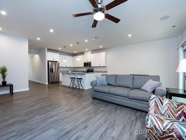 403 Park Meadows Dr, Matthews, NC 28104 - living area with dark wood-style flooring, ceiling fan, recessed lighting, and baseboards