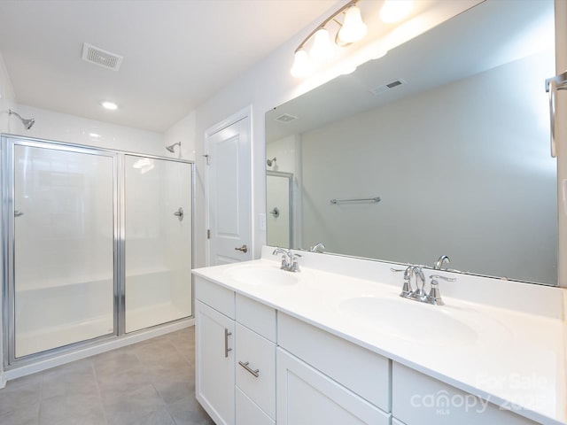 403 Park Meadows Dr, Matthews, NC 28104 - full bath featuring double vanity, a shower stall, tile patterned flooring, and recessed lighting