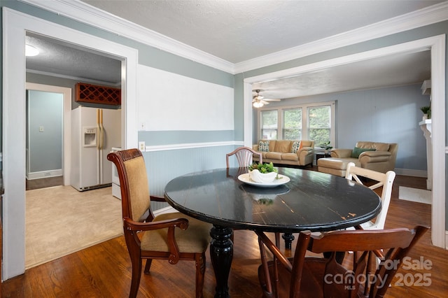 34 Admiral Ave SW, Concord, NC 28027 - dining space featuring wood finished floors, ceiling fan, crown molding, and a textured ceiling