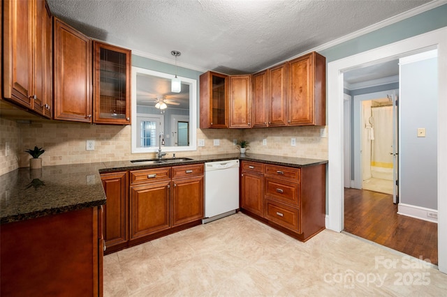 34 Admiral Ave SW, Concord, NC 28027 - kitchen with white dishwasher, a sink, brown cabinetry, crown molding, and glass insert cabinets
