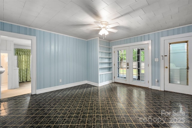 34 Admiral Ave SW, Concord, NC 28027 - empty room with ornamental molding, ceiling fan, baseboards, french doors, and built in features