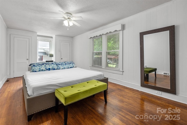 34 Admiral Ave SW, Concord, NC 28027 - bedroom with wood finished floors, a textured ceiling, baseboards, and a ceiling fan