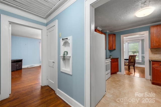 34 Admiral Ave SW, Concord, NC 28027 - corridor with ornamental molding, a desk, baseboards, and light wood finished floors