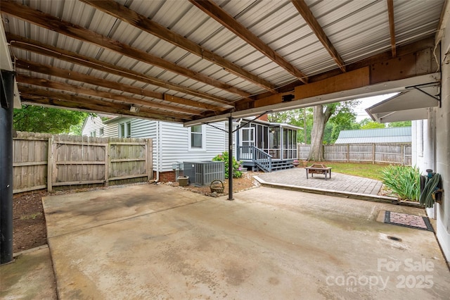 34 Admiral Ave SW, Concord, NC 28027 - fenced backyard featuring an outdoor fire pit, a sunroom, central AC unit, and a patio area
