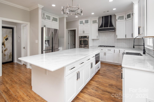 6400 Morningsong Ln, Charlotte, NC 28269 - kitchen with stainless steel appliances, premium range hood, ornamental molding, a kitchen island, and recessed lighting
