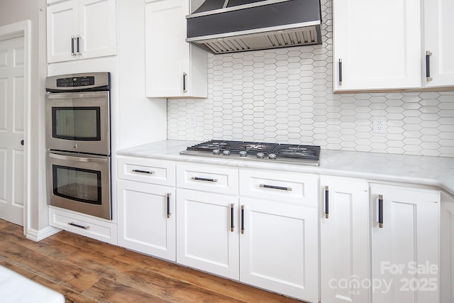6400 Morningsong Ln, Charlotte, NC 28269 - kitchen with stainless steel appliances, wall chimney range hood, decorative backsplash, and light countertops